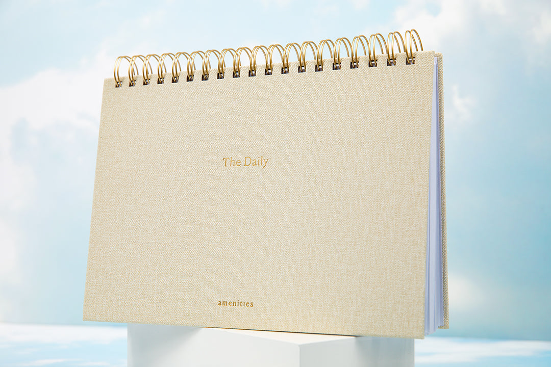 The daily journal featureing a spiral bound top and neutral linen cover