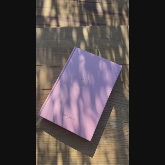 Video of Shimmery light pink Pixie Pink Thought Journal with a champagne gold thought bubble illustration centered on the cover. Opens to reveal folder pocket, ribbon bookmark and lined pages