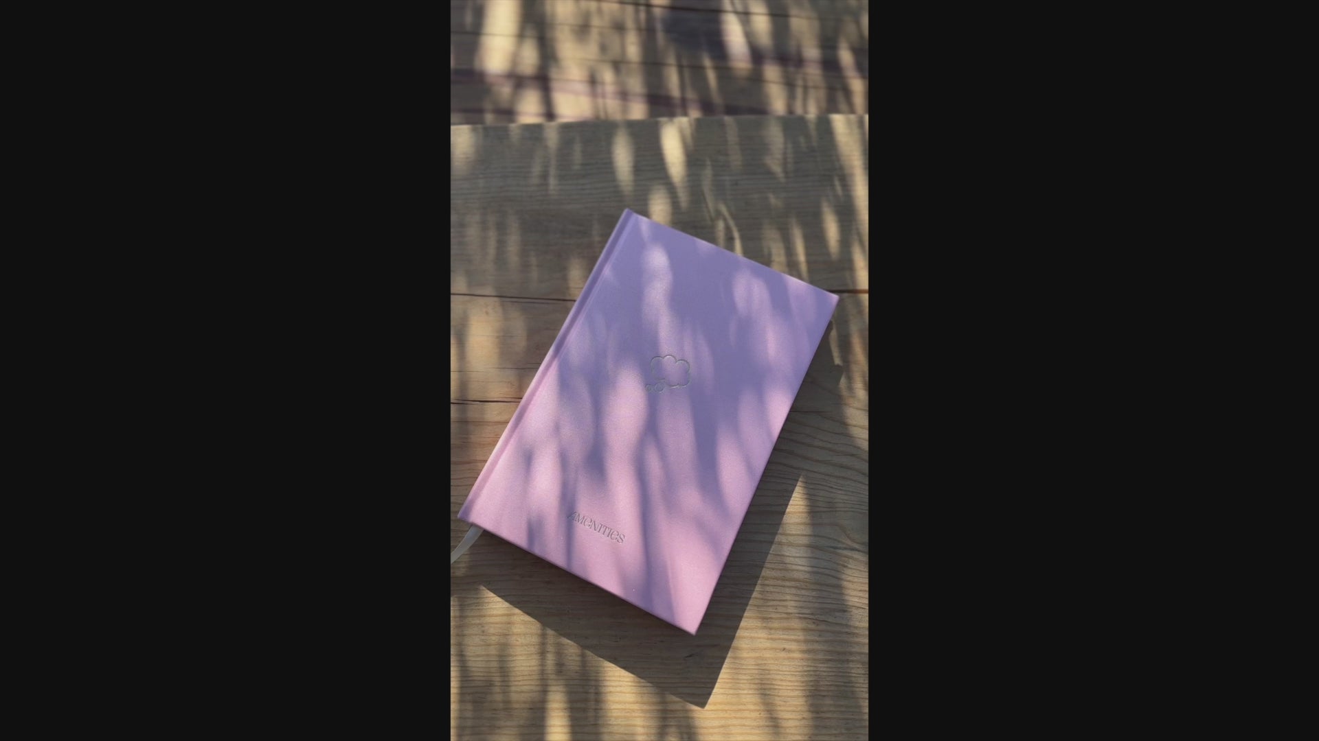 Video of Shimmery light pink Pixie Pink Thought Journal with a champagne gold thought bubble illustration centered on the cover. Opens to reveal folder pocket, ribbon bookmark and lined pages